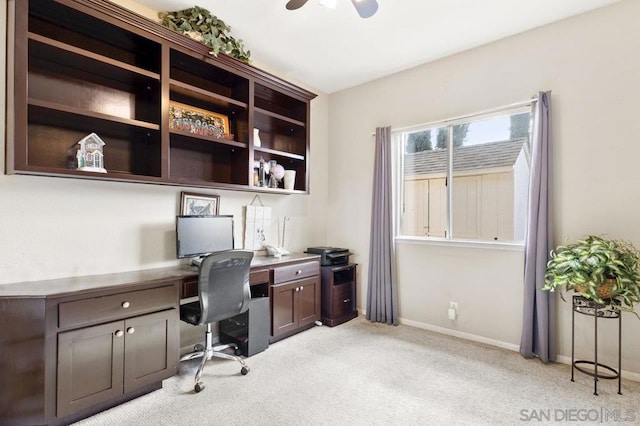 home office with light carpet and ceiling fan