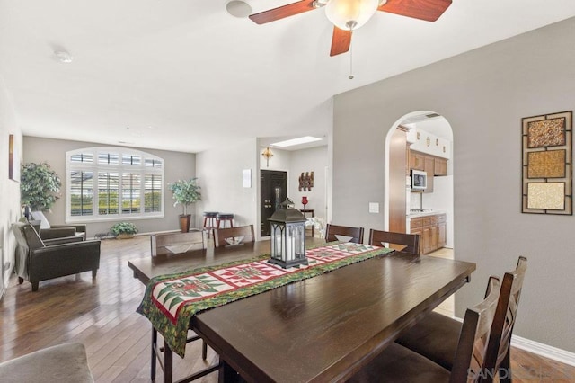 dining room with hardwood / wood-style flooring and ceiling fan