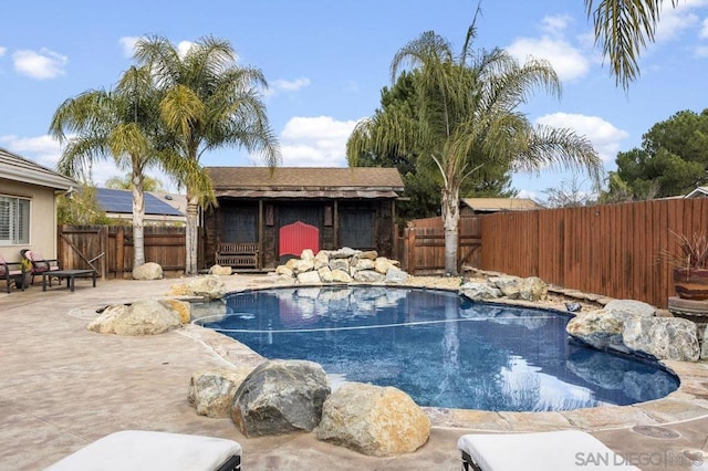 view of swimming pool with an outdoor structure and a patio area