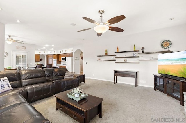 living room with light colored carpet and ceiling fan