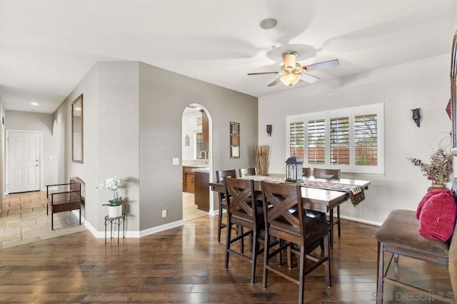 dining room with dark hardwood / wood-style floors and ceiling fan