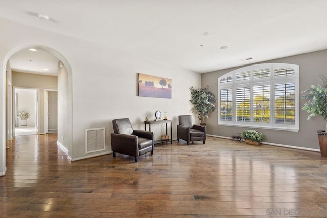 sitting room with dark hardwood / wood-style flooring