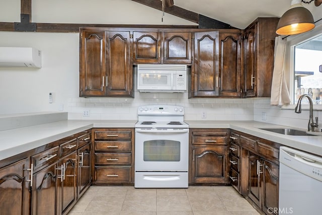 kitchen with sink, white appliances, dark brown cabinets, and vaulted ceiling