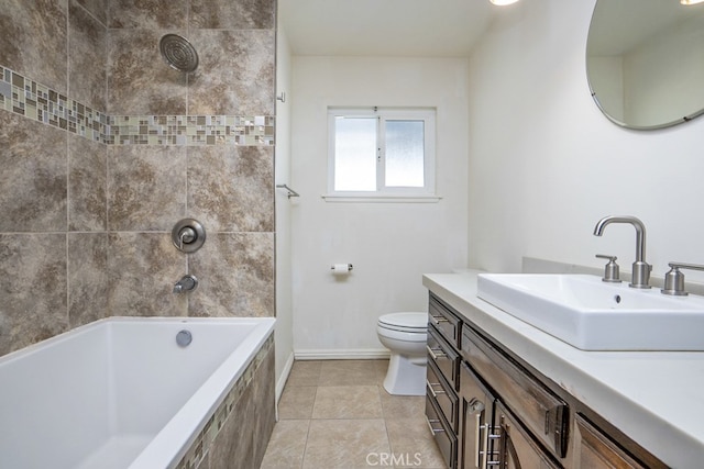 full bathroom with vanity, tiled shower / bath, tile patterned floors, and toilet