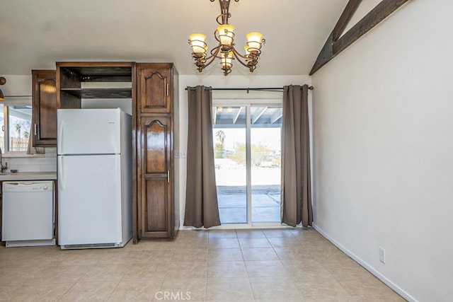 kitchen featuring a notable chandelier, white appliances, and light tile patterned flooring