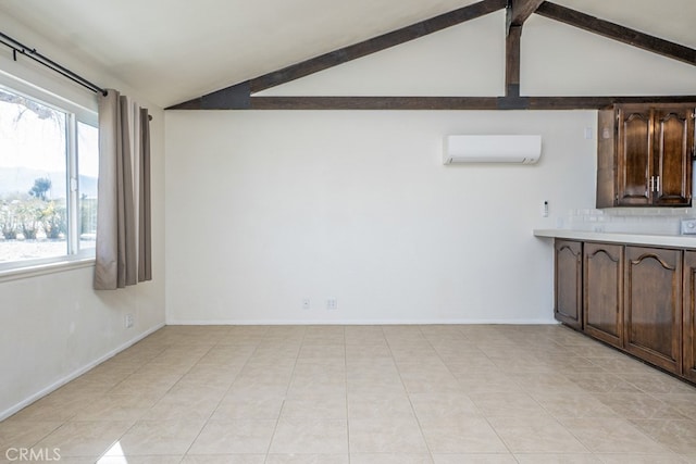 interior space featuring vaulted ceiling with beams, backsplash, dark brown cabinets, and an AC wall unit