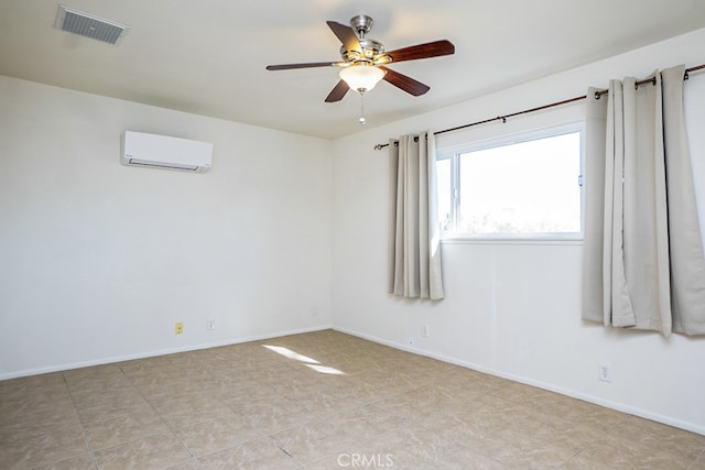 spare room featuring an AC wall unit and ceiling fan