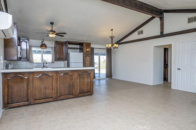 kitchen with pendant lighting, sink, vaulted ceiling with beams, white refrigerator, and tasteful backsplash