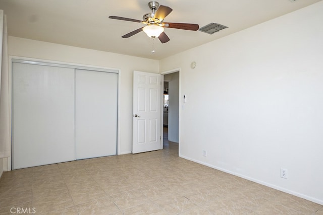 unfurnished bedroom with a closet and ceiling fan