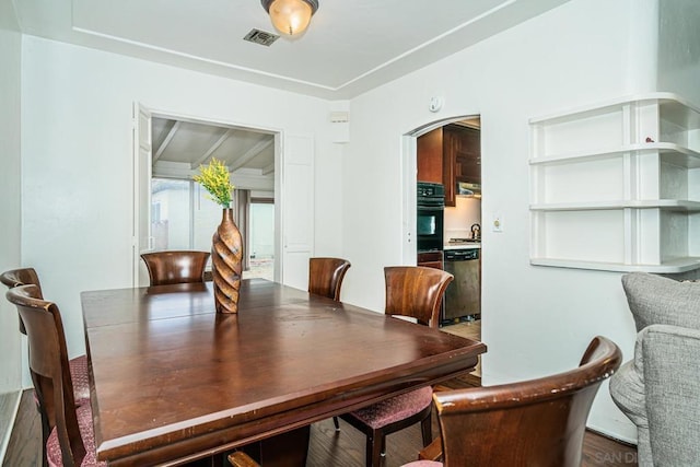 dining space with dark hardwood / wood-style flooring