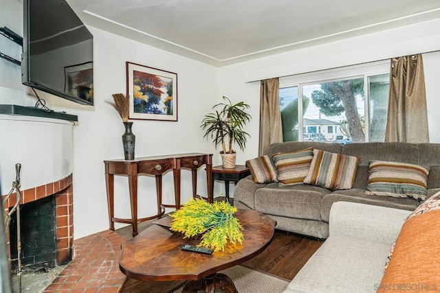 living room with a brick fireplace