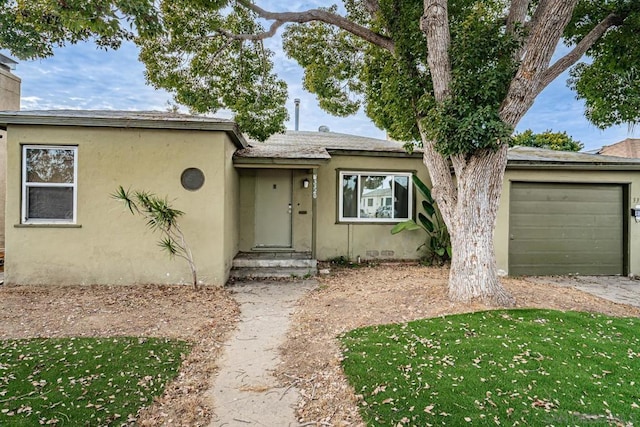 view of front of home with a garage and a front yard