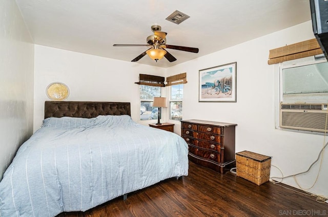 bedroom featuring cooling unit, dark wood-type flooring, and ceiling fan