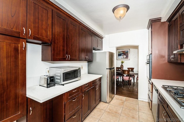 kitchen with light tile patterned floors and appliances with stainless steel finishes