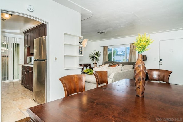 dining area with light tile patterned floors