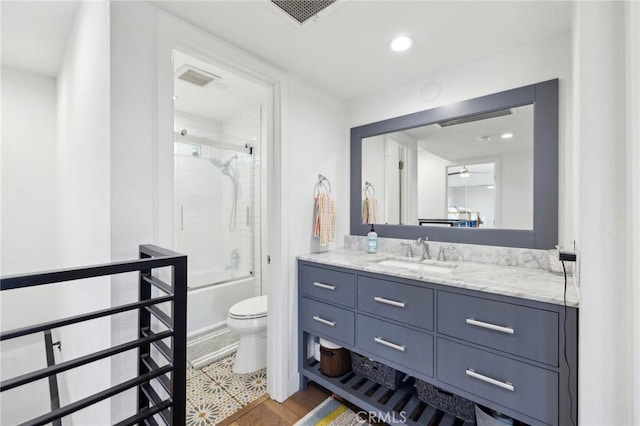 full bathroom featuring bathtub / shower combination, vanity, toilet, and hardwood / wood-style floors