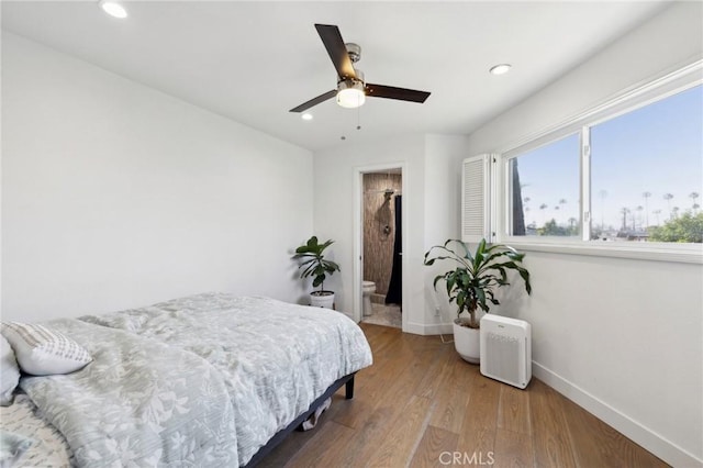 bedroom featuring ceiling fan, hardwood / wood-style floors, and ensuite bath