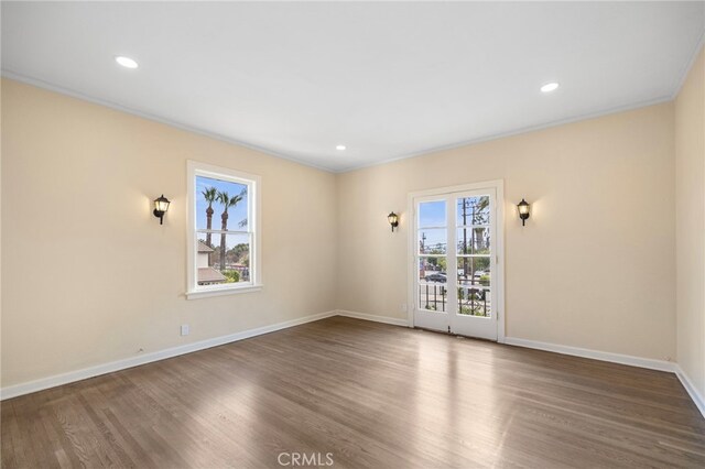 unfurnished room with hardwood / wood-style flooring