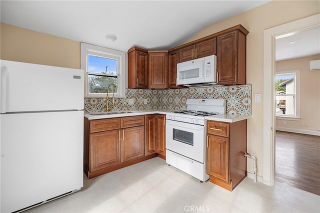 kitchen featuring tasteful backsplash, white appliances, a healthy amount of sunlight, and sink