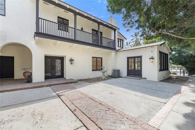 back of property featuring cooling unit, a patio, and french doors