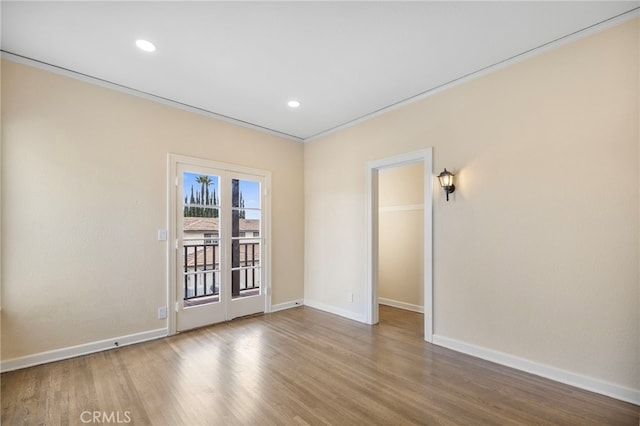 unfurnished room with ornamental molding and hardwood / wood-style floors