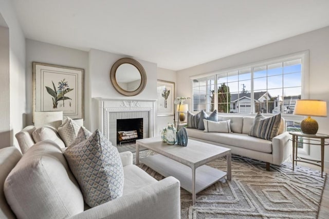 living room featuring a fireplace and plenty of natural light