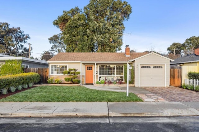 single story home with a garage and a front yard