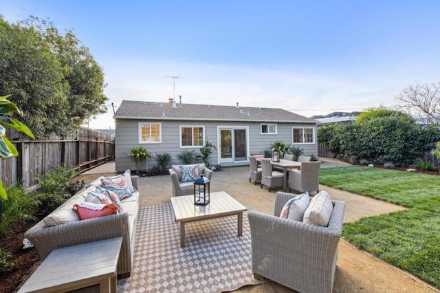 back of house featuring a yard, outdoor lounge area, and a patio