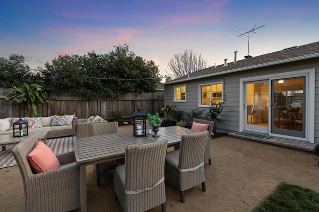 patio terrace at dusk featuring outdoor lounge area