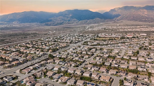 aerial view at dusk featuring a mountain view