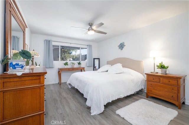 bedroom featuring hardwood / wood-style flooring and ceiling fan