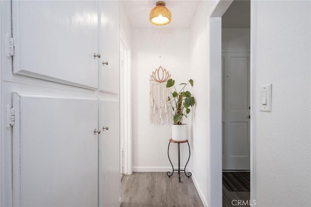 corridor with light hardwood / wood-style floors