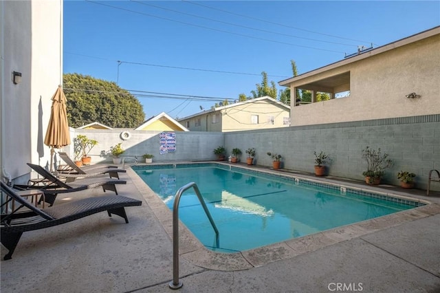 view of swimming pool with a patio area