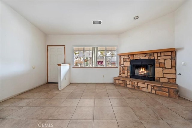 unfurnished living room with light tile patterned floors and a fireplace