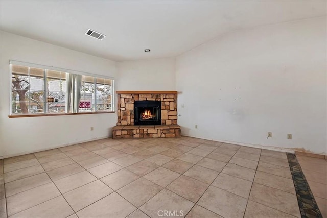 unfurnished living room with light tile patterned floors and a fireplace