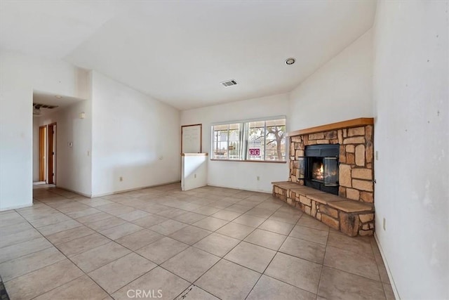 unfurnished living room featuring light tile patterned flooring and a fireplace