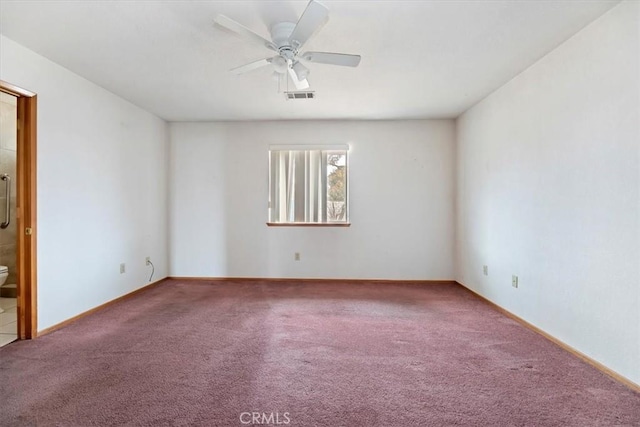 unfurnished room with ceiling fan and carpet