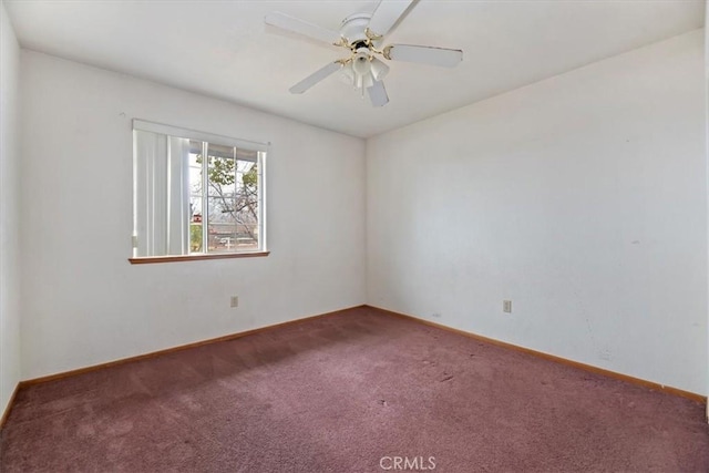 spare room featuring ceiling fan and carpet