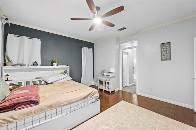 bedroom featuring visible vents, dark wood-type flooring, ornamental molding, a ceiling fan, and baseboards