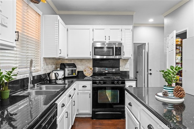 kitchen with sink, dark stone countertops, ornamental molding, black appliances, and white cabinets