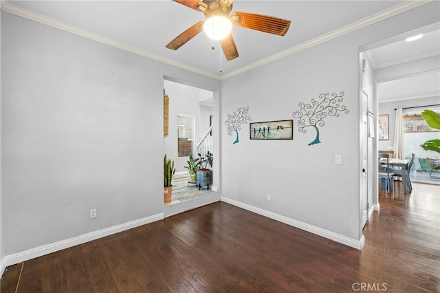 unfurnished room featuring a ceiling fan, dark wood-style flooring, crown molding, and baseboards