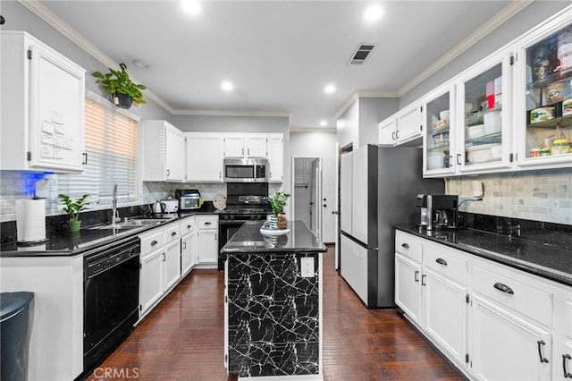 kitchen with sink, black appliances, white cabinets, and a kitchen island