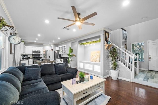 living room with ornamental molding, ceiling fan, and dark hardwood / wood-style flooring