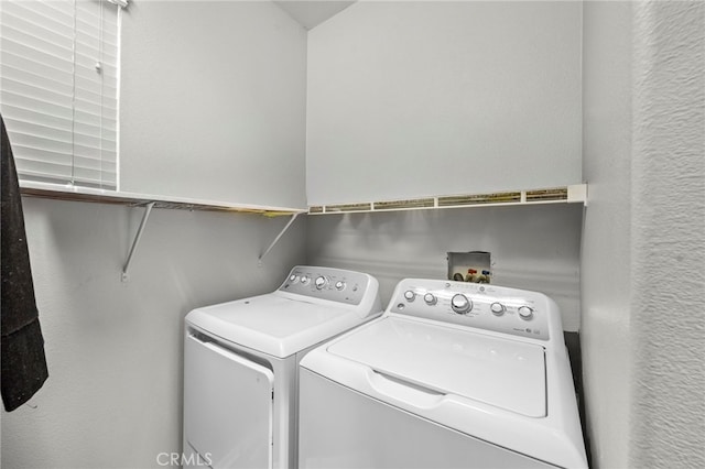 clothes washing area with washer and dryer