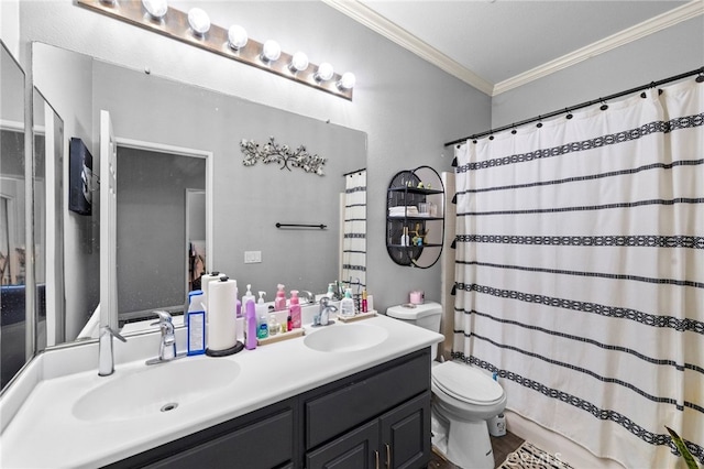 bathroom featuring toilet, double vanity, ornamental molding, and a sink