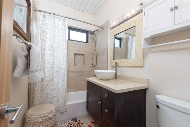 full bathroom featuring vanity, toilet, and shower / tub combo