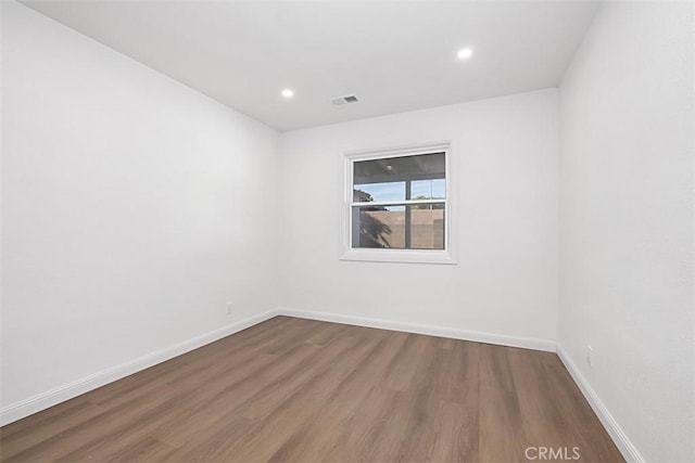 spare room featuring dark hardwood / wood-style flooring