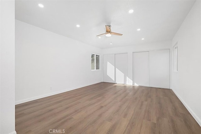 spare room with dark hardwood / wood-style floors and ceiling fan