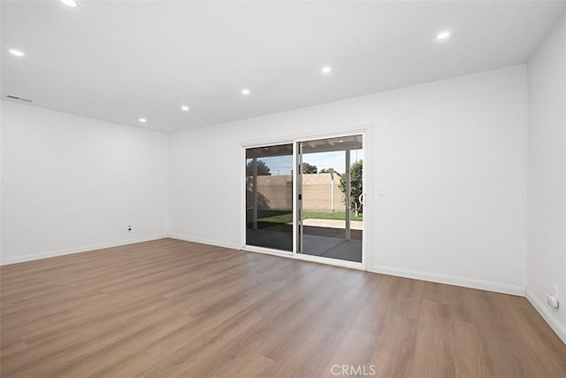 spare room featuring hardwood / wood-style flooring