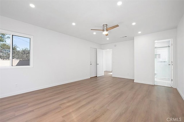 spare room featuring ceiling fan and light hardwood / wood-style flooring